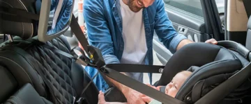 Baby Capsule Installation (2026 Update) 3 Britax B-Pod capsule professionally installed with father smiling at baby
